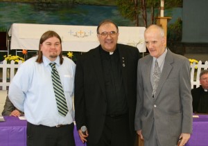 Eric Baumgardner, Fr. Enzo Addari and Bob Neff the Resident of the Year at St. Louis Center