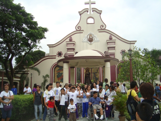 Group of Guanella Center pilgrims at a shrine in Manila
