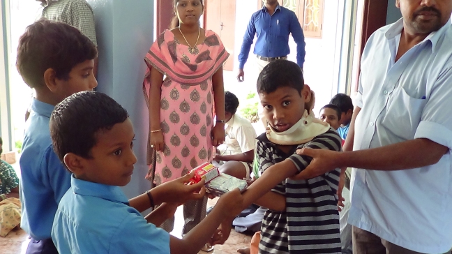 Indian school children give gifts to Developmentally disabled children