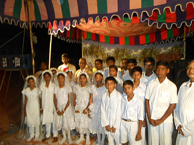 2 dozen First communicants and the celebrants in India