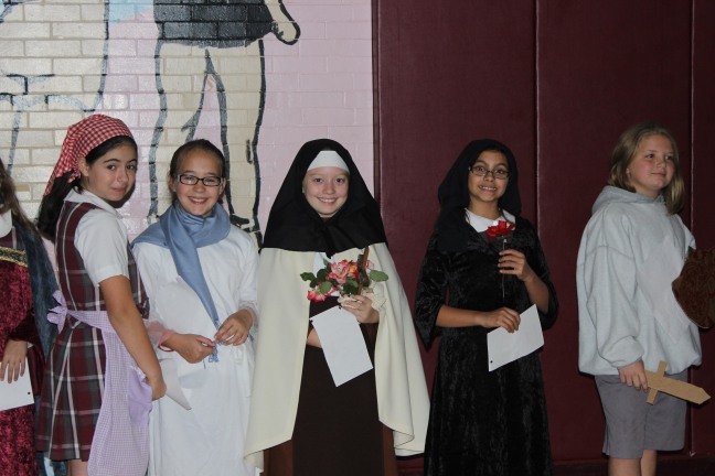 School girls in Saint costumes