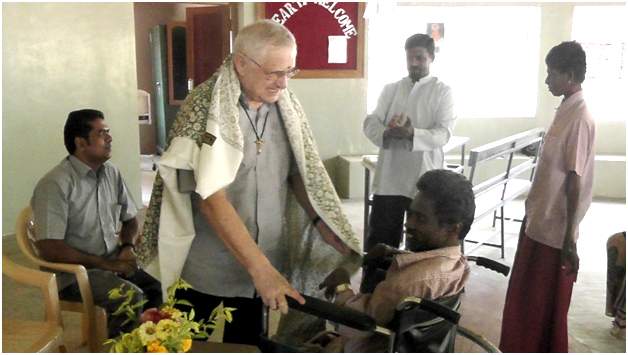 Fr. Crippa greets disabled man